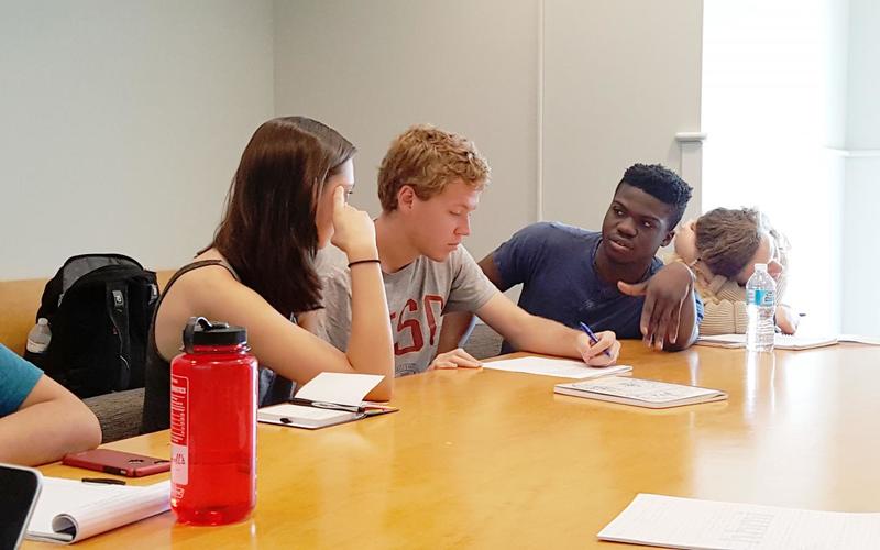 REU students discussing a worksheet during an activity