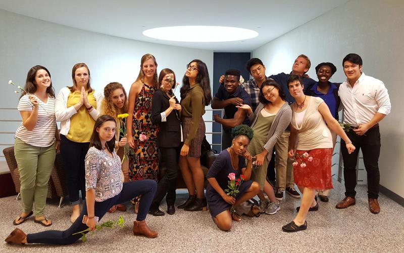 REU student group are all striking a silly pose while wearing professional attire