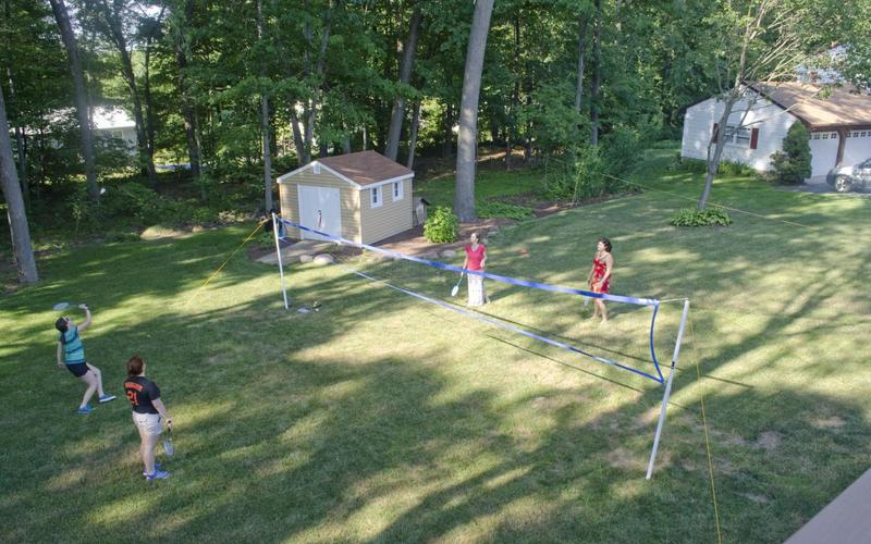 Two pairs of students playing badminton