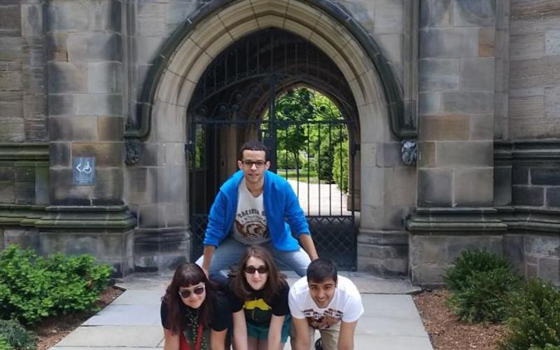 4 REU participates form a human pyramid outside of a Yale building