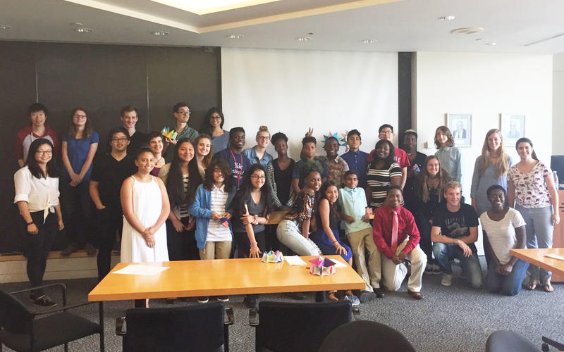 Group of REU students and participants at an outreach event