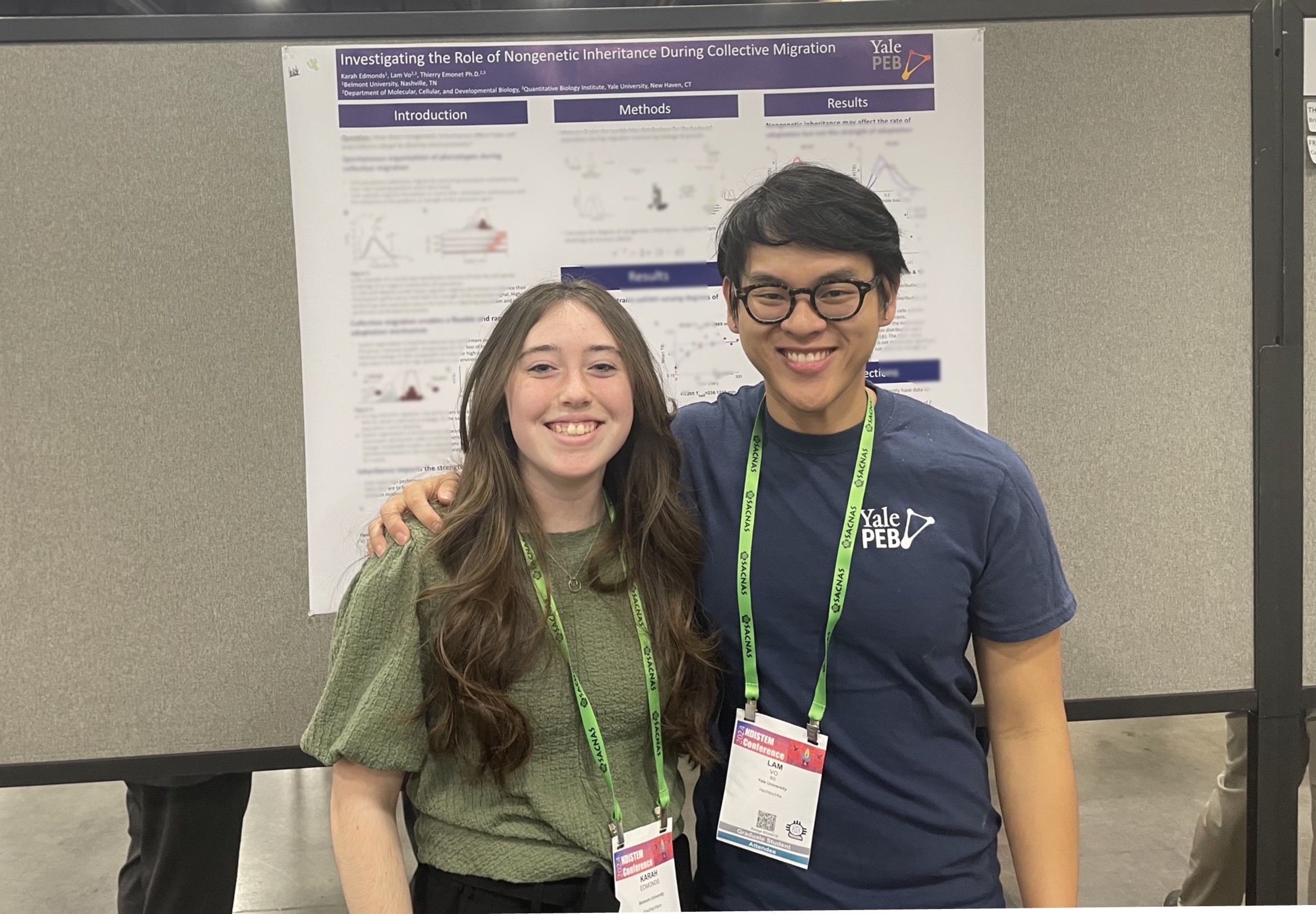 Lam and Karah standing in front of Karah's poster