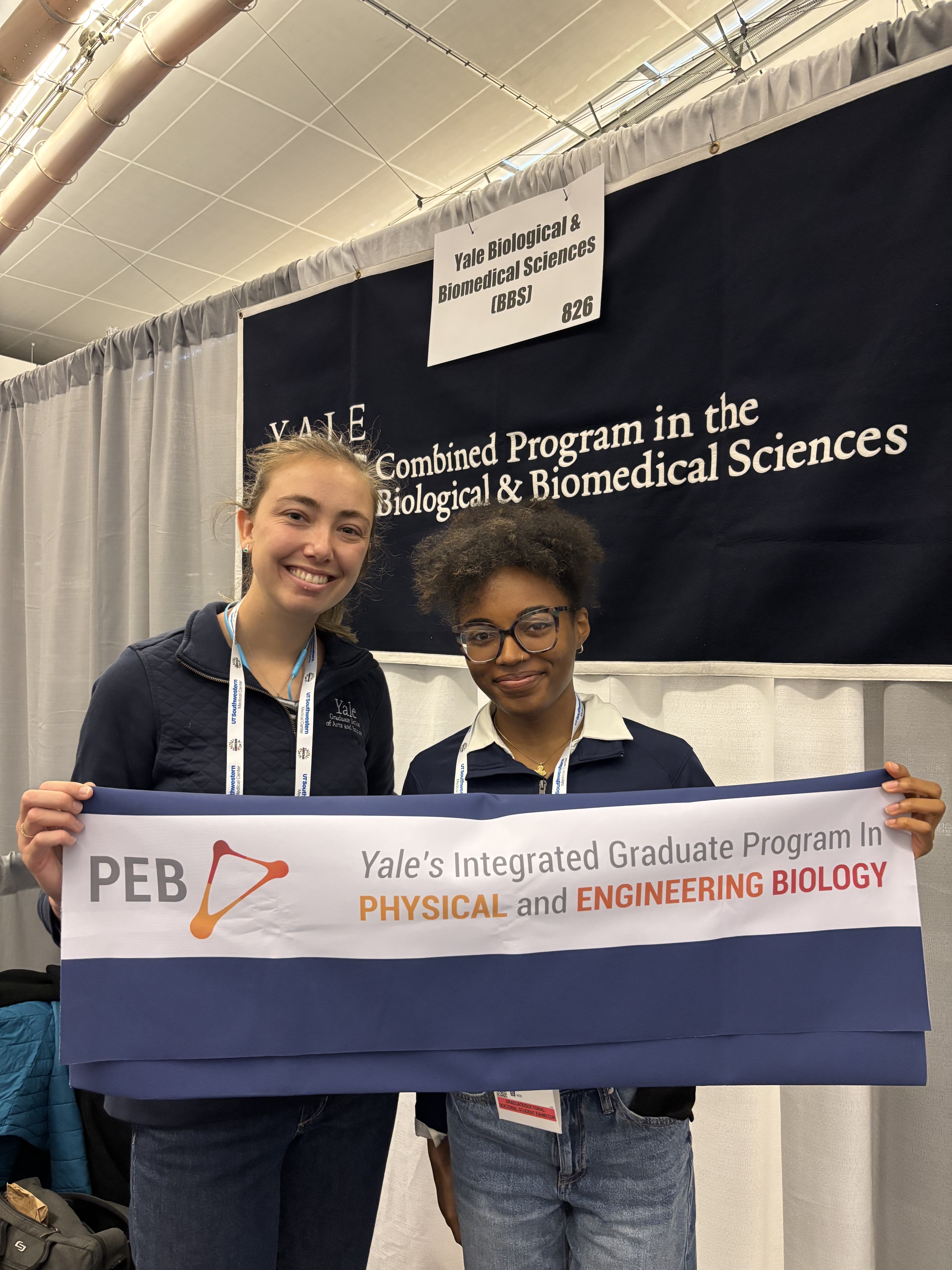 Emma and Latavia holding a PEB banner