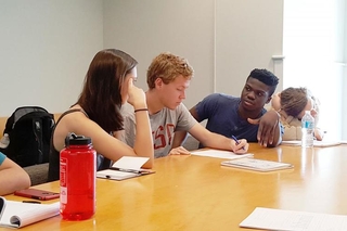 REU students discussing a worksheet during an activity