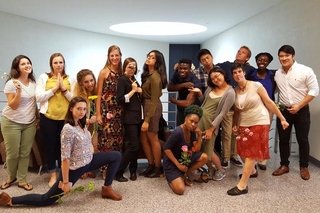 REU student group are all striking a silly pose while wearing professional attire