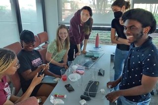 Group of REU students test out experiments for science outreach event