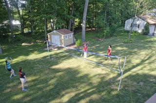 Two pairs of students playing badminton