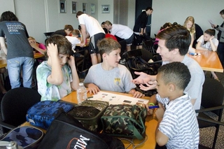 REU student talks to a group of 3 kids