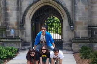 4 REU participates form a human pyramid outside of a Yale building