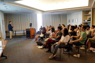 REU student giving an oral presentation in front of an audience