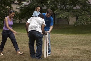 Two students fix a cricket set-up