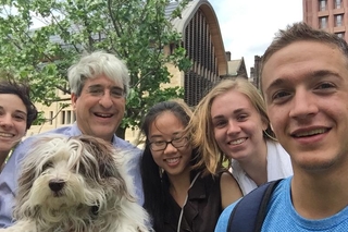 Selfie of REU students with Peter Salovey and a small fluffy dog