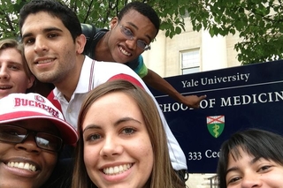 Selfie of 5 REU students in front of the sign for the Yale School of Medicine