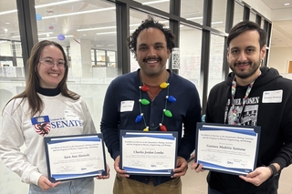 Sara, Charles, and Gustavo holding their award certificates