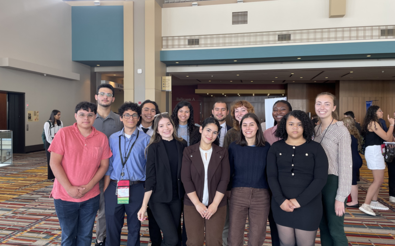 Group image of 2023 REU participants and Dr. Carley at the LANS conference