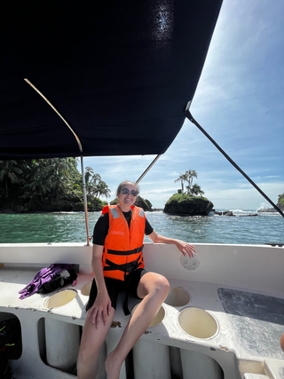 Sara on a boat collecting samples