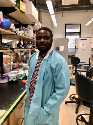 Archie in the lab wearing a labcoat