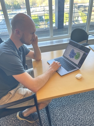 Jake looking at a pair of protein structure on his computer