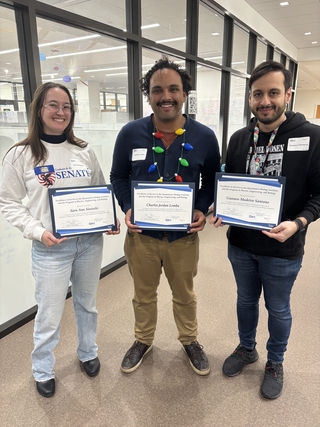 Sara, Charles, and Gustavo holding their award certificates